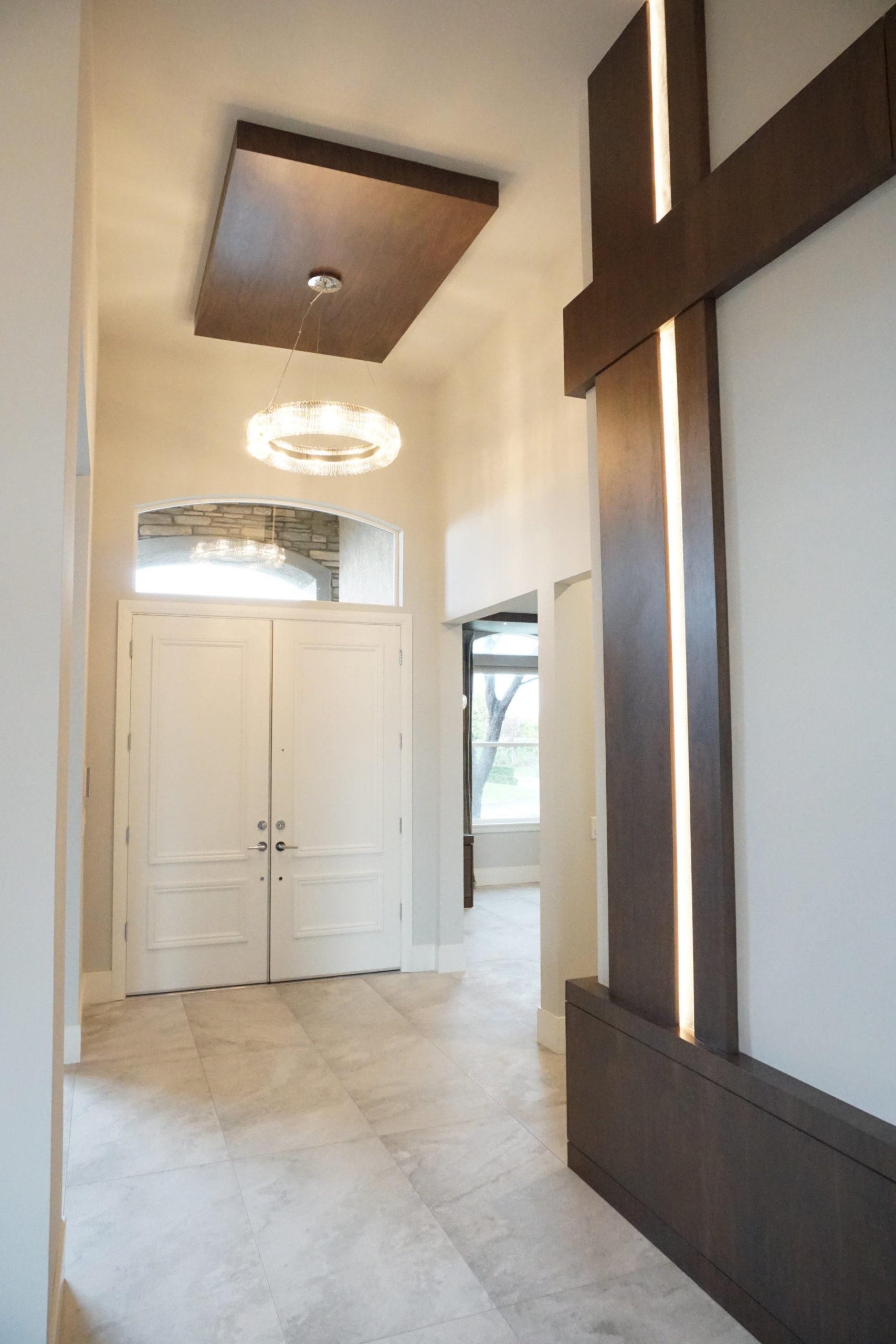 Front entry of home with light fixture and dark wood accents