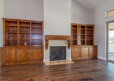 Great room with wood floors, fireplace and built in shelving