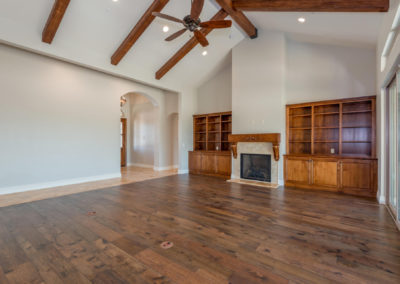 Great room with wood floors, fireplace and built in shelving