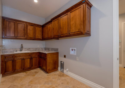 Laundry room with custom cabinets and sink
