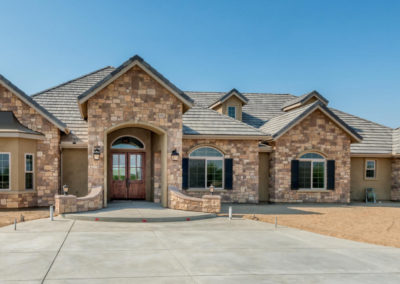 Stone faced home with large driveway