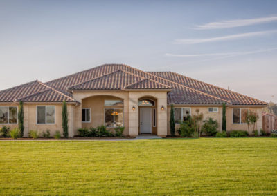 Beige colored home with windows and green grass