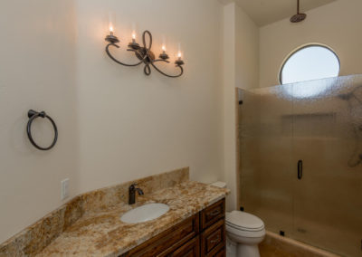 Bathroom showing sink, toilet and glass shower door