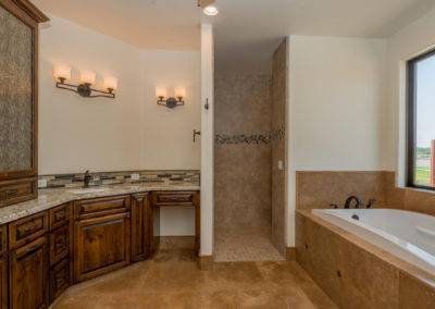 Bathroom with soaker tub and shower with tile backsplash
