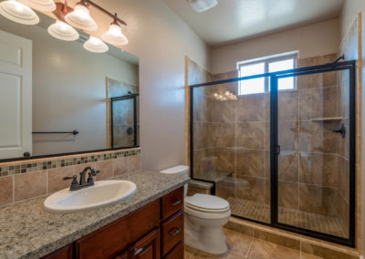 Bathroom with glass shower and single sink