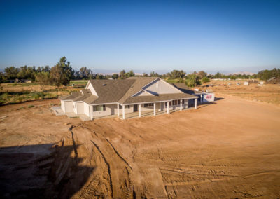 Arial view of newly constructed home on dirt lot