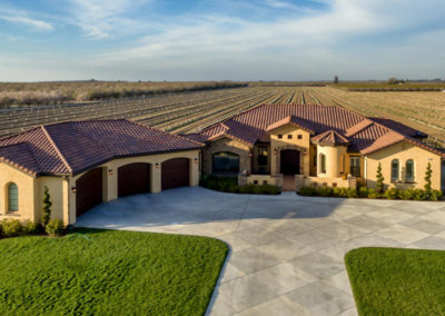 Large home after construction with fields in the back
