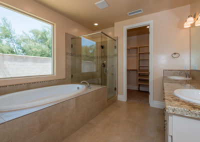 Soaking tub and glass shower in bathroom