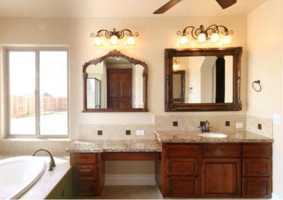 Bathroom with tub and windows and double mirrors