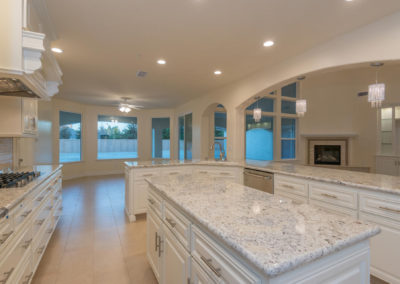 Open area kitchen overlooking great room and dining area