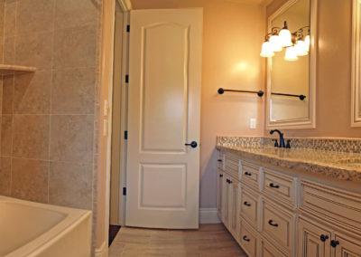 Bathroom with shower and double sinks and mirrors