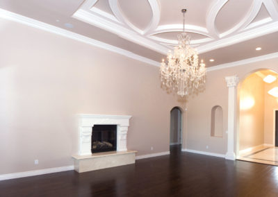 Living area with dark wood floors and hanging chandelier