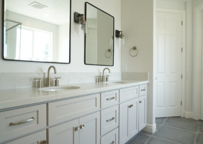 White bathroom with two sinks and two mirrors
