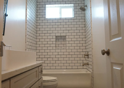 White bathroom with subway tile and window