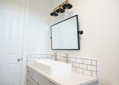 Double bathroom sink with mounted mirror and light fixture