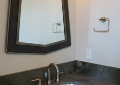 Mirror hanging over bathroom sink and counter