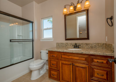 Bathroom with glass shower and granite sink