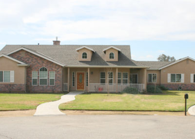 Ranch style home with brick accents and walkway