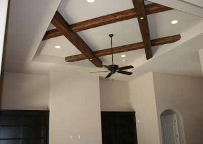 Ceiling with exposed beams and ceiling fan