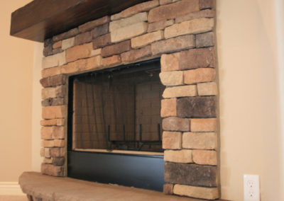 Stone fireplace and tan walls