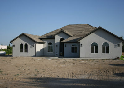 Under construction grey home with arched windows