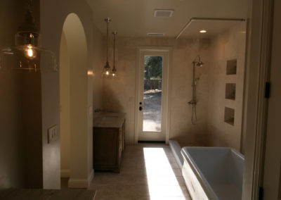 bathroom showing tub, shower and glass door