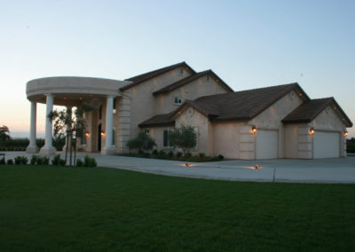 Large home with columns at dusk