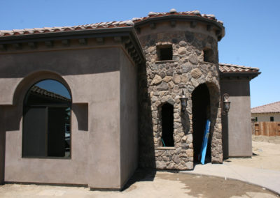 Curved stone entryway of home under construction