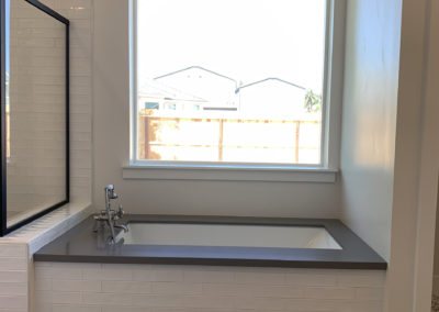 Soaker tub with a window overlooking and patterned floor