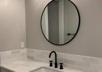 Bathroom sink and mirror with light fixture