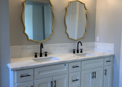 Double sink and mirrors in bathroom with light fixtures