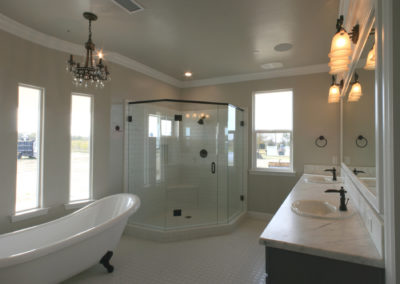 Clawfoot tub with glass shower in bathroom