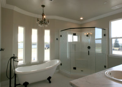 Clawfoot tub and glass shower in taupe bathroom