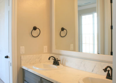 Double bathroom sink with mirror and light fixture