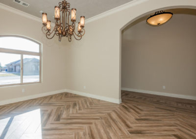 Dining room with chandelier and chevron pattern floor