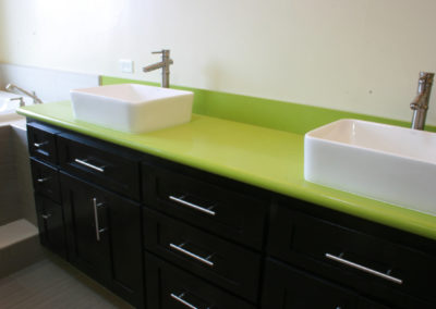 Modern bathroom green counter top and sinks