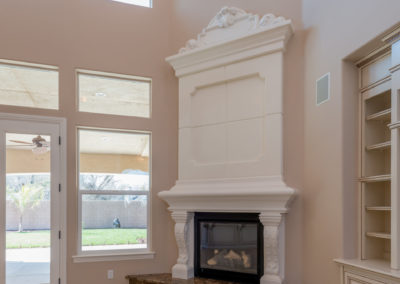 Tan walls with white fireplace and marble floor