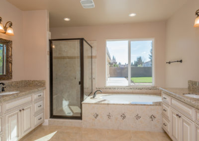 Bathroom with glass shower and soaker tub with large window
