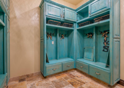Custom laundry cabinets in teal