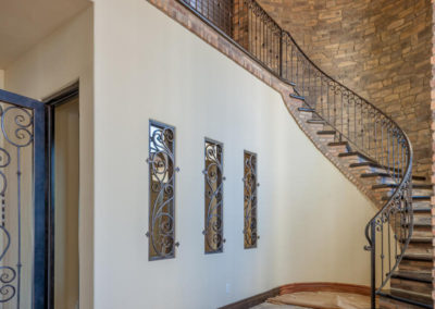 Curved entry stairs with stone wall