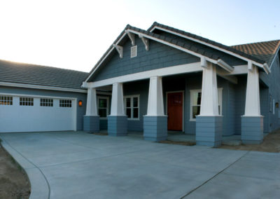 Blue house with garage and door