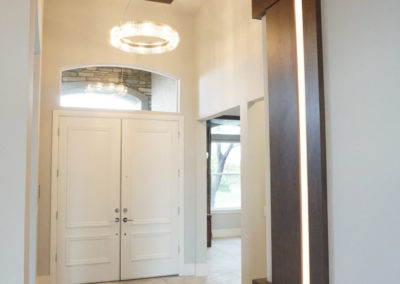 White double door entry way with dark brown wooden accents