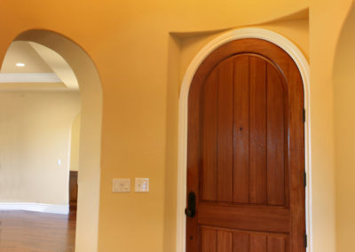 Arched entry way with marble inlay floor and chandelier