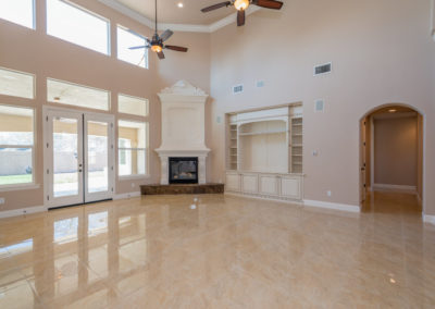 Open area great room with fireplace and marble floors
