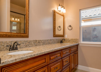 bathroom double sink with mirrors and light fixtures
