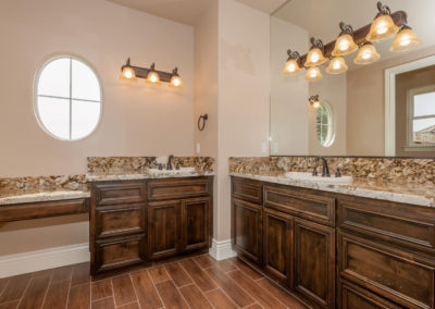 Bathroom with granite counter tops and lighting