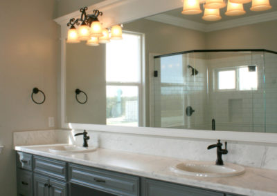 Double sink bathroom vanity with light fixture and mirror