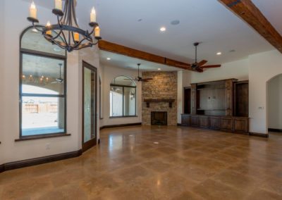 Large room with exposed beams and tile floor