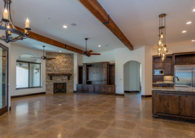 Large room with exposed beams and tile floor