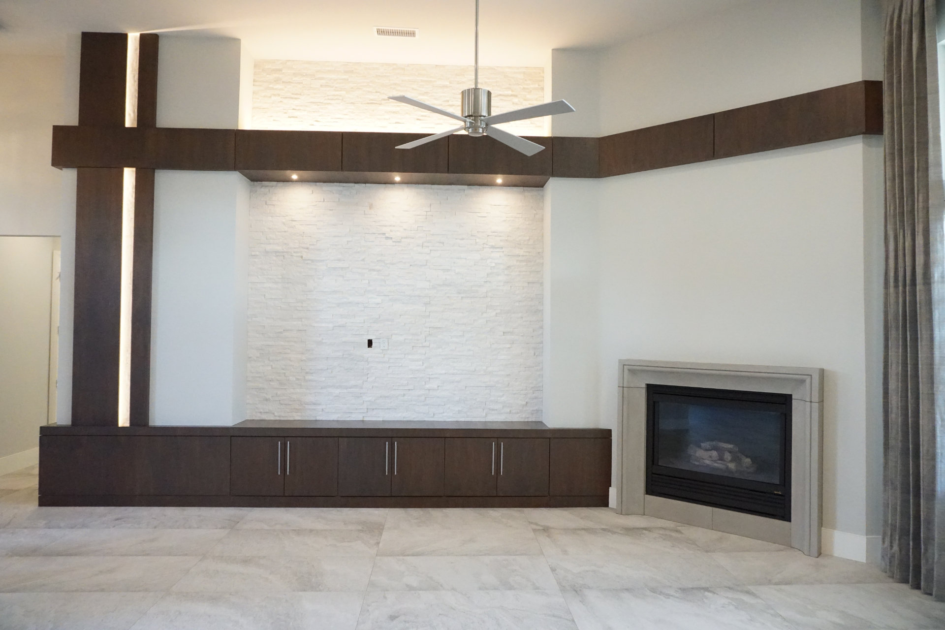 Unfurnished living room with fireplace and ceiling fan